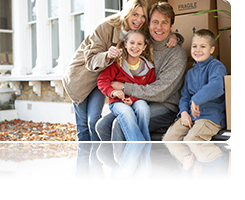 image: family in front of house with boxes